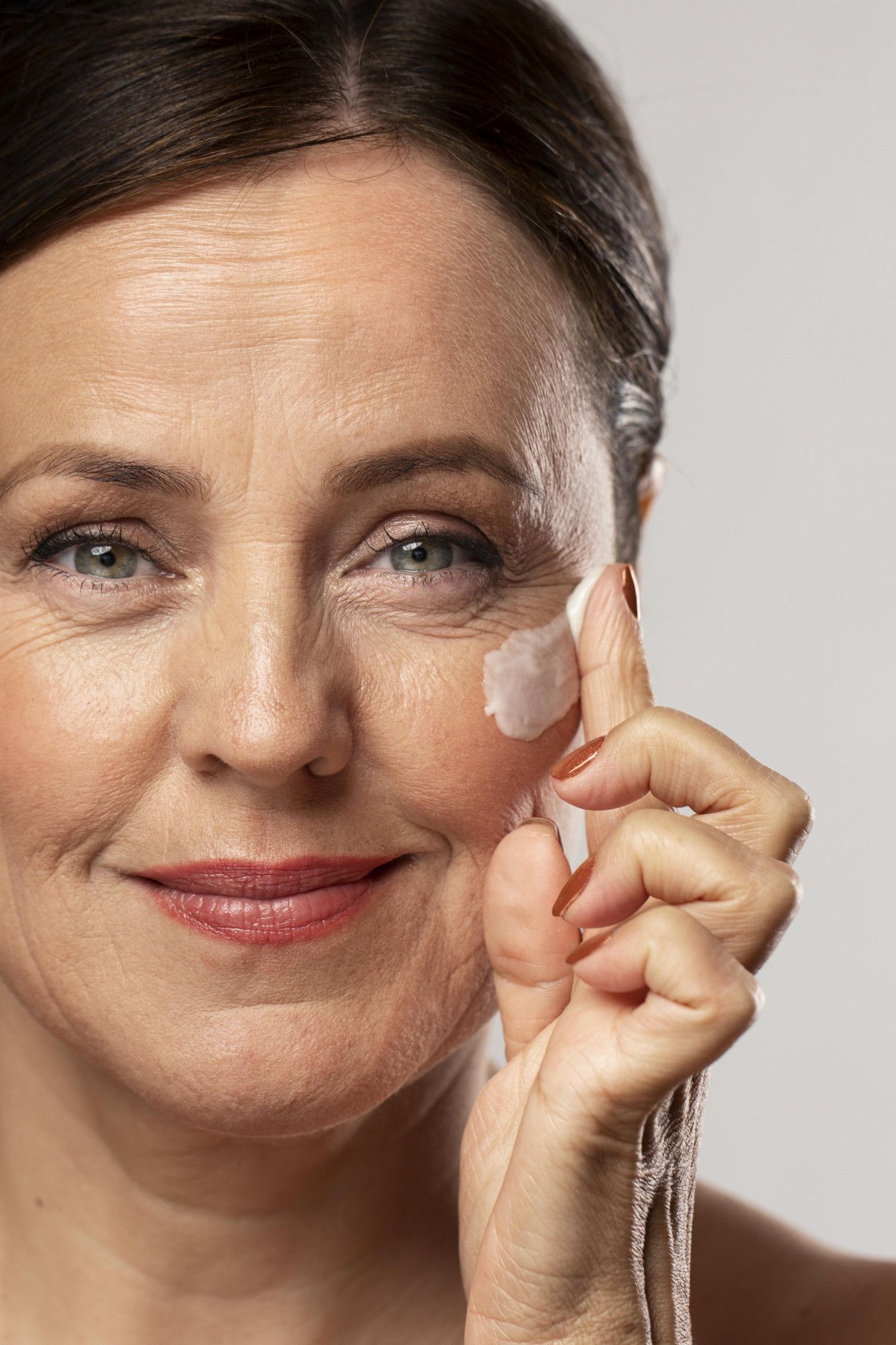 older-woman-using-moisturizer-her-face.jpg